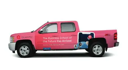 A pink truck with the words " business school of the future has arrived ".